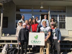 Photo of CRAFT student group holding CRAFT poster at Woodstock Union
