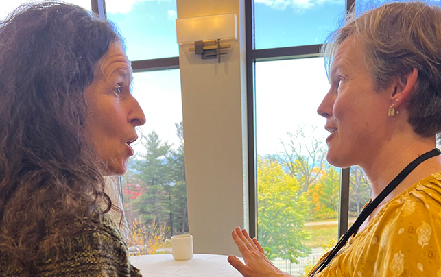 Cropped photo: Photo of Anne Bergeron & Abbie Bowker in conversation at the 2022 Annual Retreat. Evocative image depicting the innovative and future-forward educational practices supported by The Rowland Foundation, aiming to inspire and motivate educational reform and creativity.