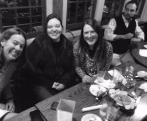 black and white photo of educators enjoying a meal after school change work