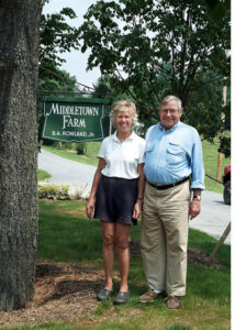 Photo of Barry and Wendy in front of Middletown Farm sign