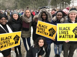 Photo of large student crowd gathered with "Black Lives Matter" signs