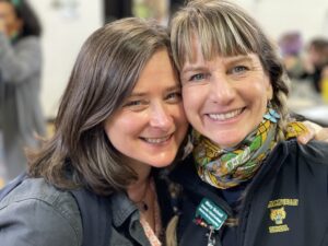 Photo of two innovative educators Jeanie Phillips and Mary Schell standing cheek to cheek