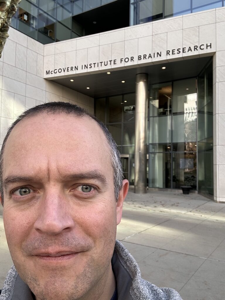 Photo of Adam Murray in front of the McGovern Center for Brain Research at MIT as he studies brain research in learning